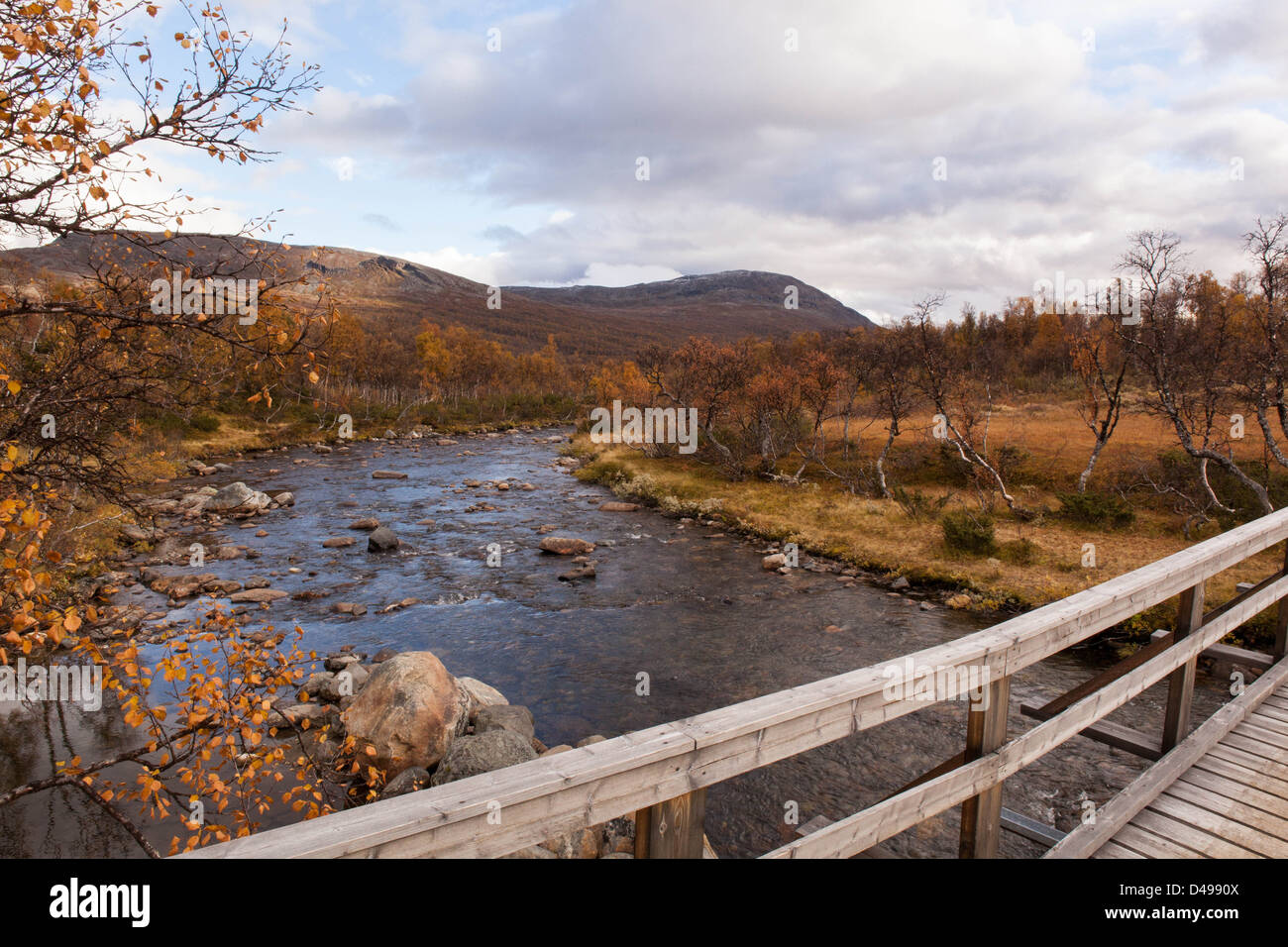 Bridge over a river in autumn time with mountains in the background. Trekking Storulvån in Jämtland, Sweden, Scandinavia. Stock Photo