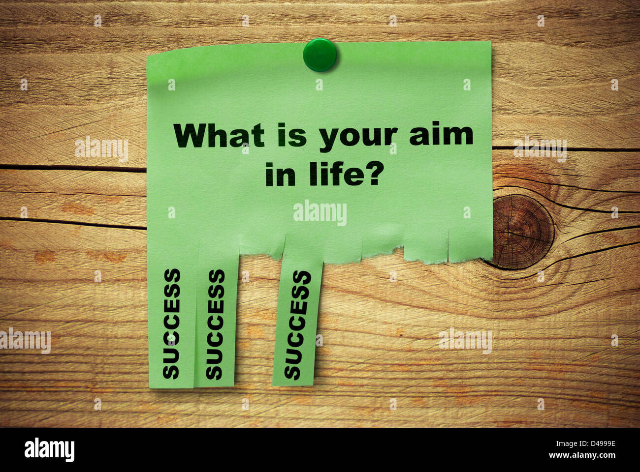 green tear off notice where it is written what is your aim in life, success over a wooden background Stock Photo