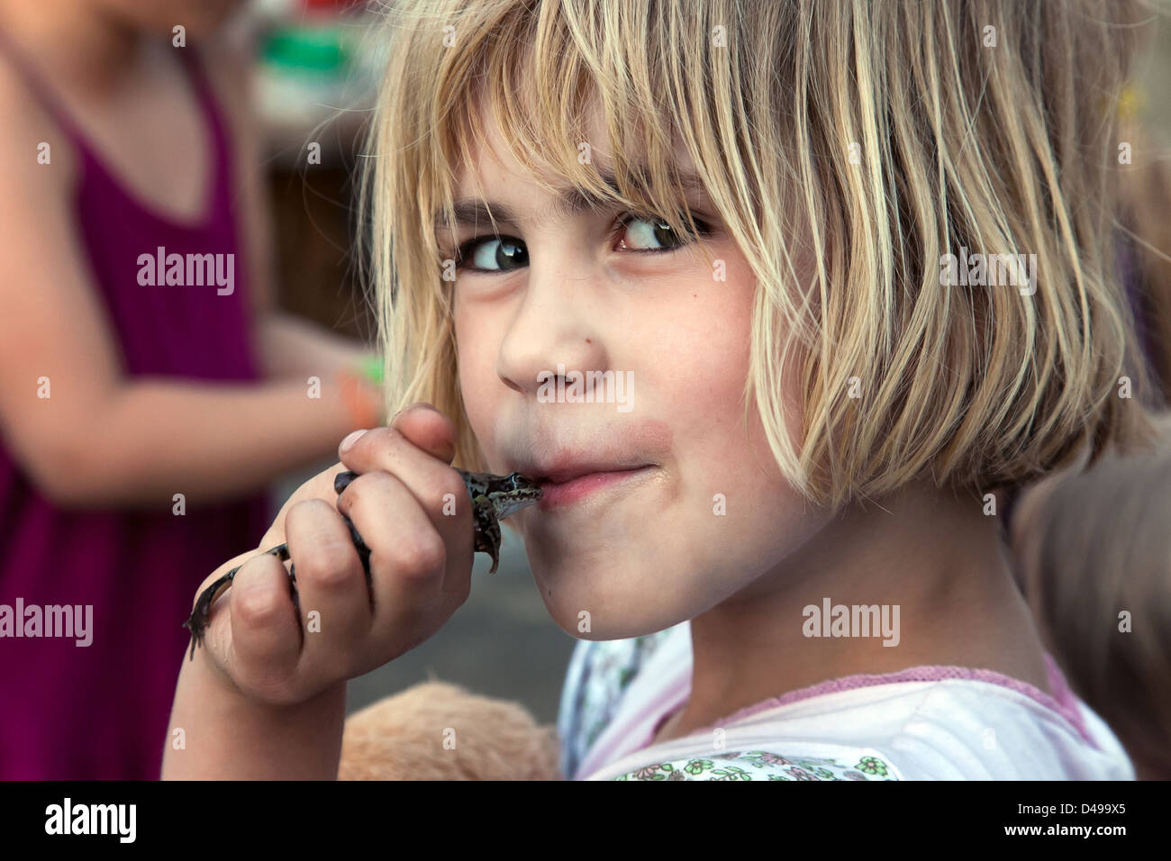 Rühstädt, Germany, a girl kisses a frog Stock Photo