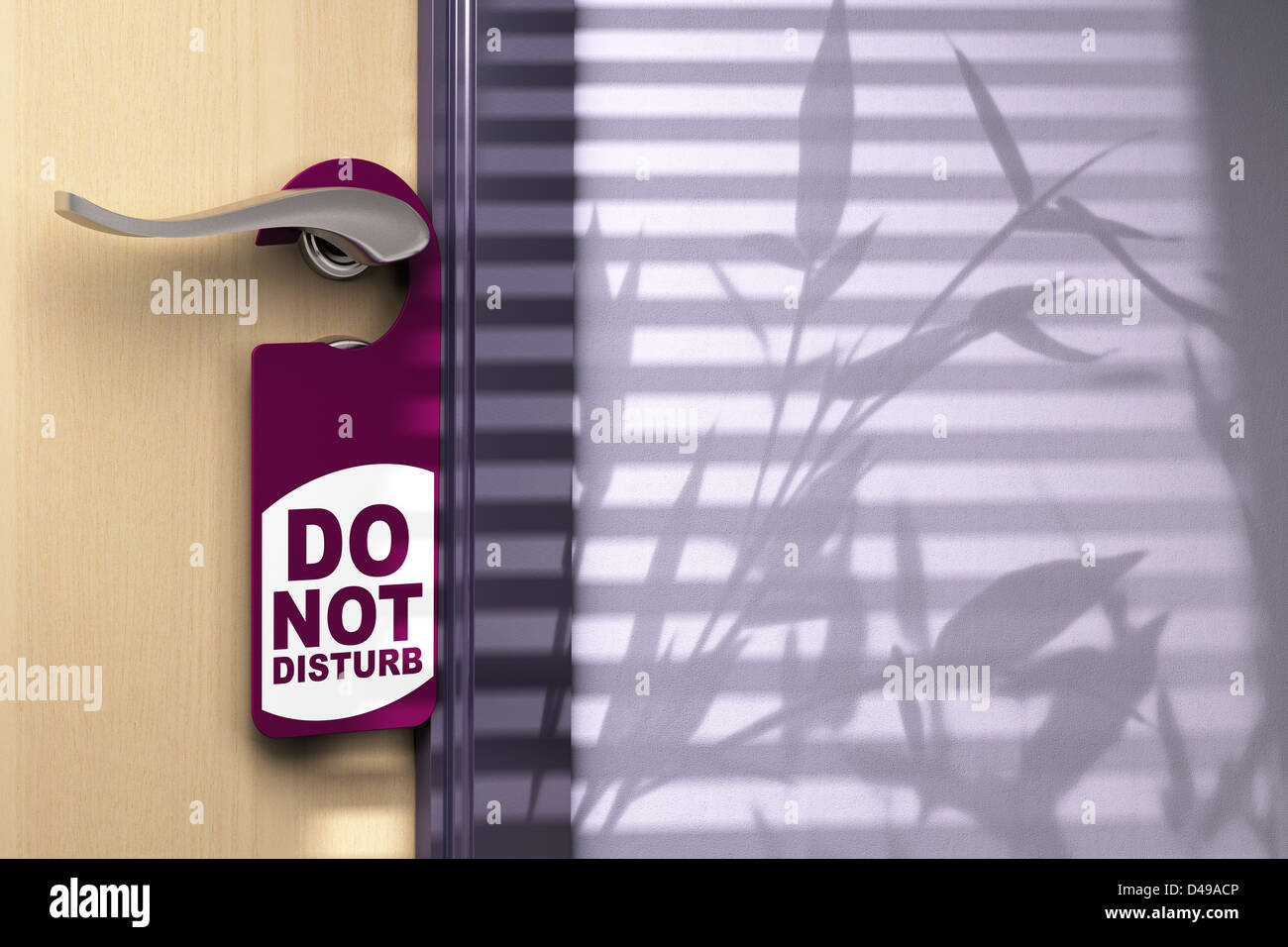 door hanger where it is written do not disturb on a closed door with shadow of a plant Stock Photo
