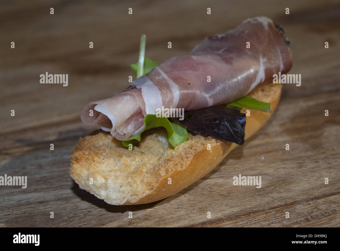 toasted crouton with ham and black olive Stock Photo