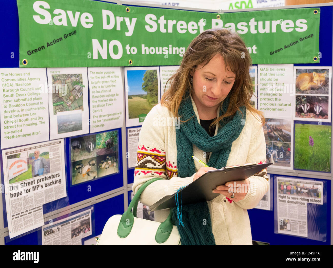 Eastgate Shopping Centre, Basildon, Essex, UK. 9th March 2013.  A member of the Basildon public adds her name to a petition to protest against the building of 750 new houses on the Dry Street Pastures greenfield site.  A unique wildlife habitat will be lost to the people of Basildon once this development goes ahead.  Photographer: Gordon Scammell/Alamy Live News Stock Photo