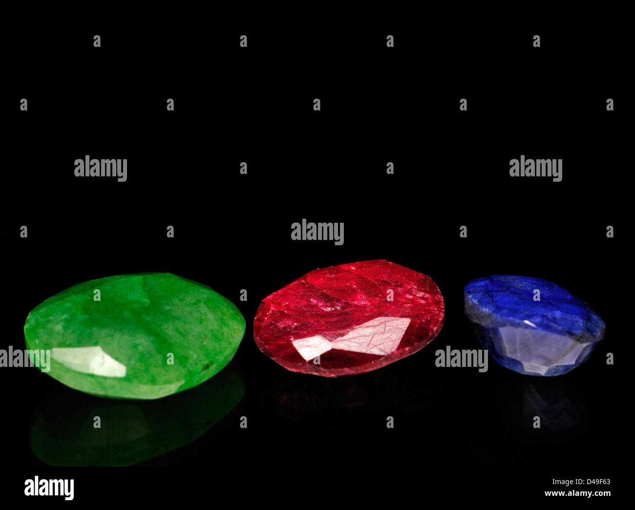 Low grade (opaque) Ruby, Sapphire and Emerald - faceted Stock Photo