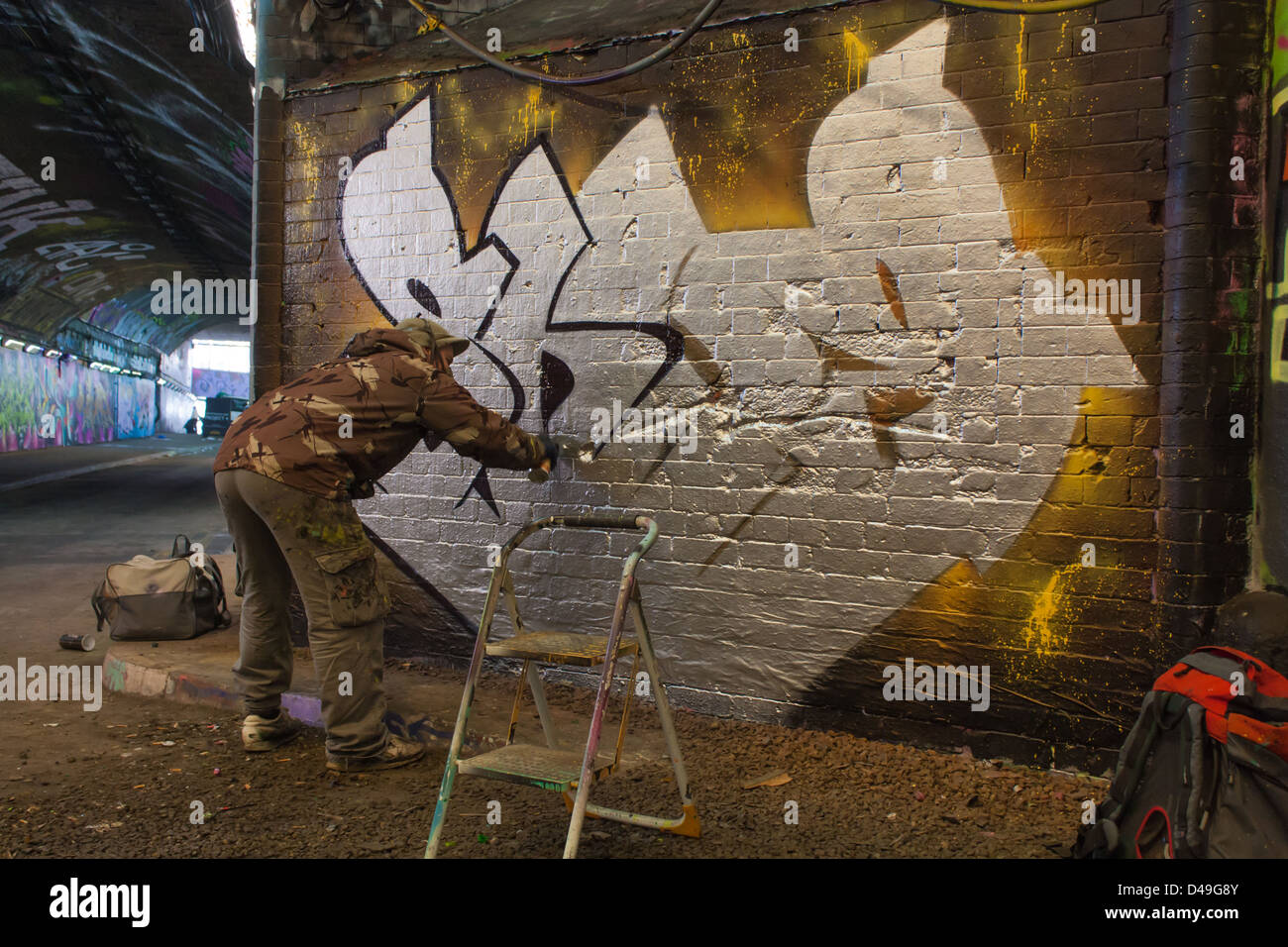 Graffiti artist at work Stock Photo