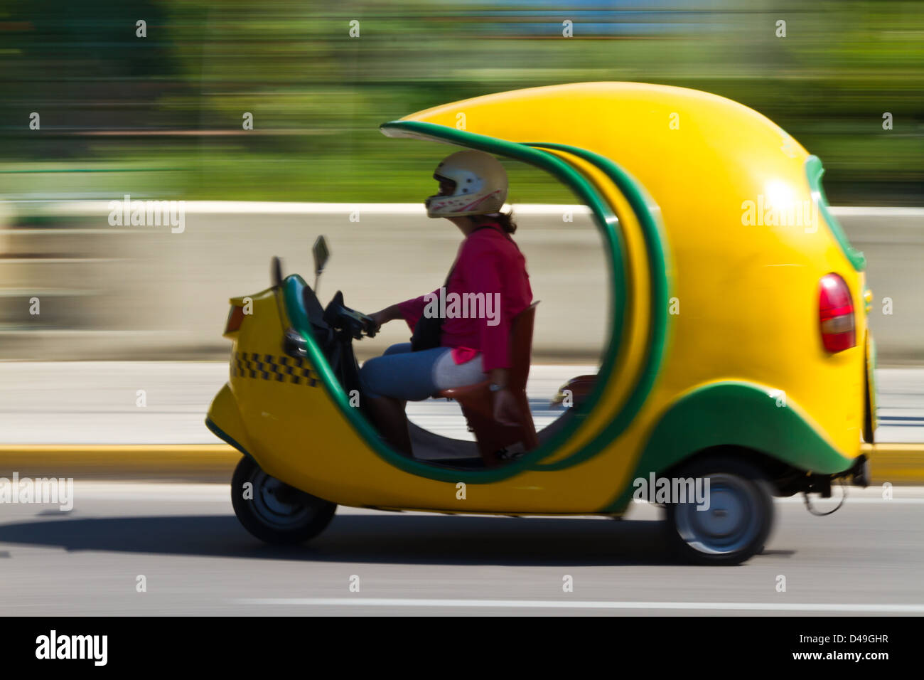 Cocotaxi,an auto rickshaw type taxi vehicle in Cuba. Motion blur focus on taxi Stock Photo