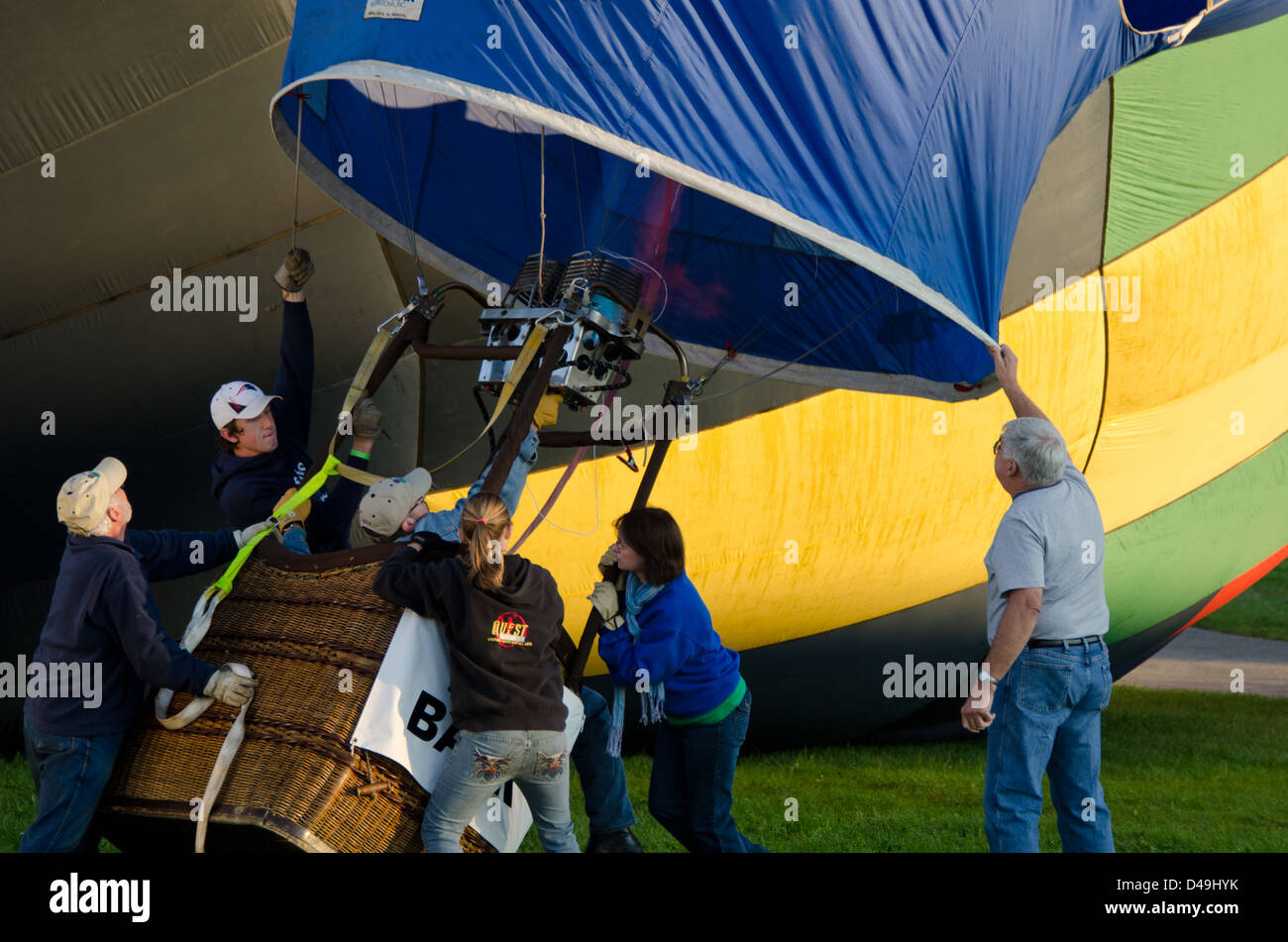 A hot air balloon slowly rises upright as the propane burner heats the air in the envelope Stock