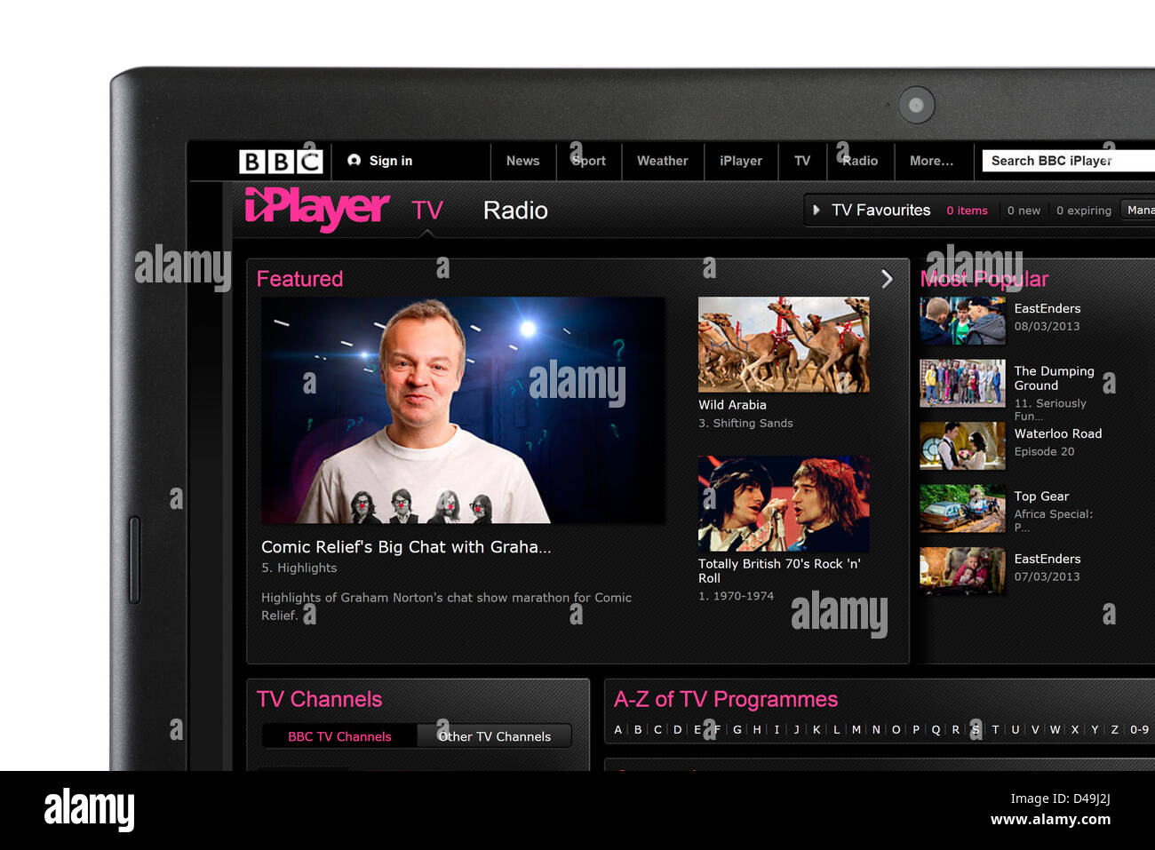 Watching TV via BBC iPlayer on a laptop computer Stock Photo