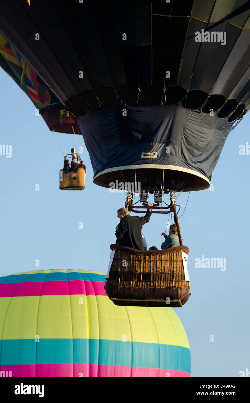 Three hot air balloons rise into a clear blue sky Stock Photo - Alamy