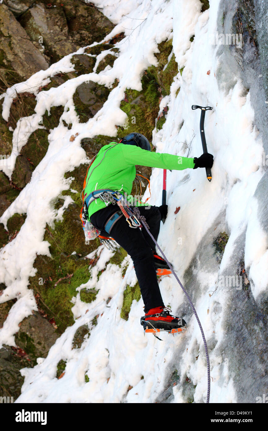 mountaineer beginning the ascent on a big wall in winter Stock Photo
