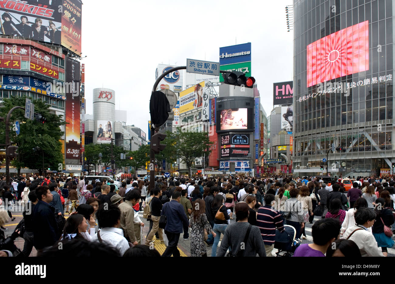 Busiest pedestrian intersection in world, Shibuya crossing in front of train station is always packed with Tokyo shoppers Stock Photo