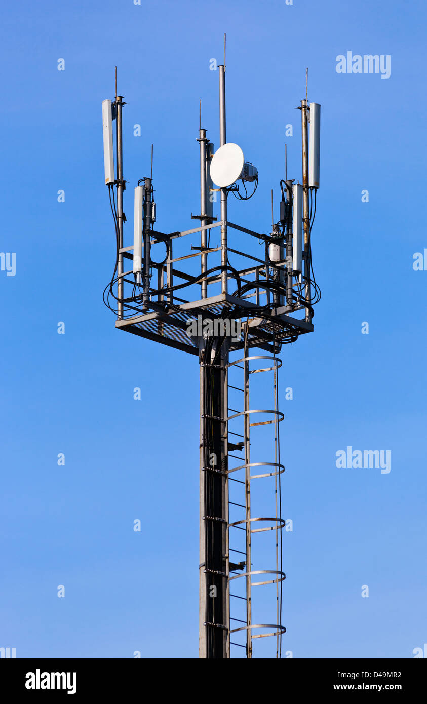 A radio communications tower against blue sky Stock Photo Alamy