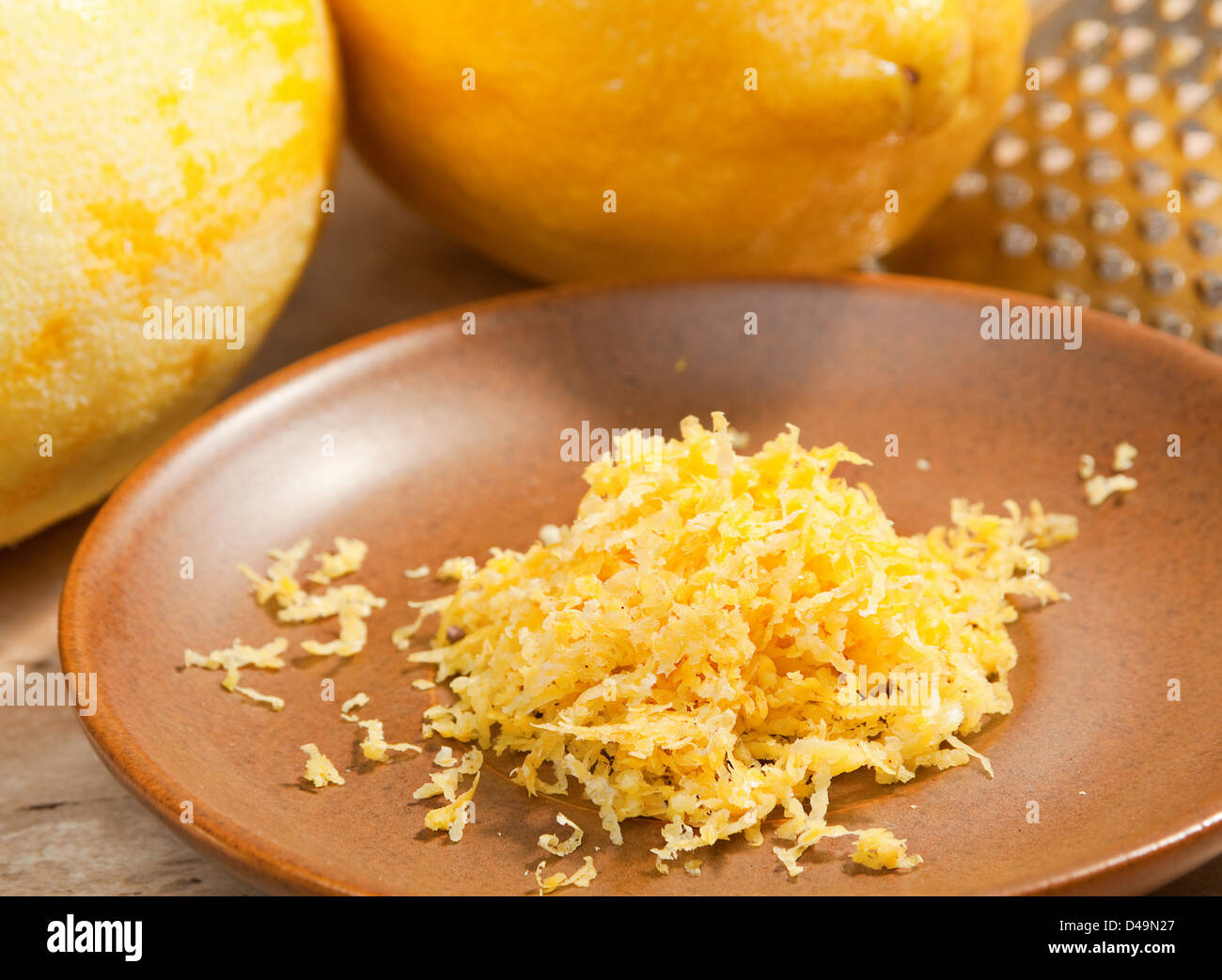 Lemon ingeredient zest on brown plate Stock Photo
