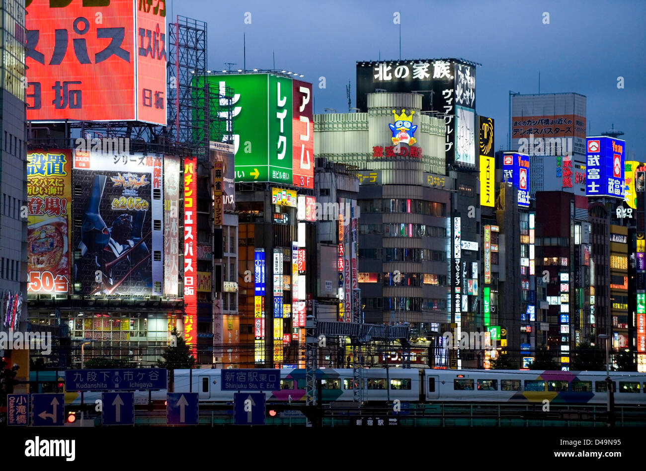 Neon advertising signs on building facades light up evening in shopping and adult entertainment district of Kabukicho in Tokyo. Stock Photo