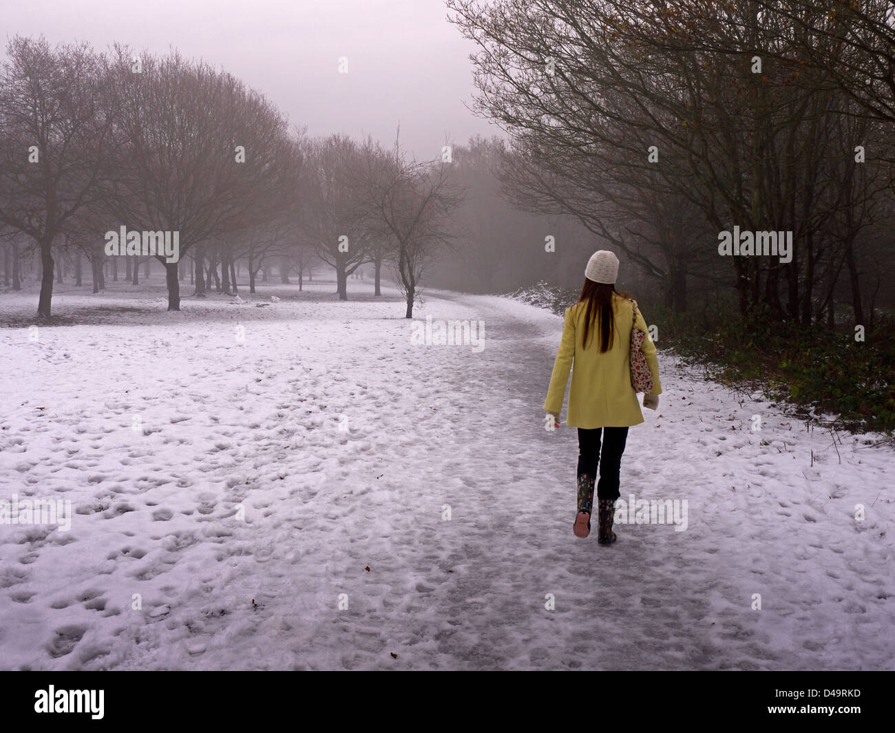 Girl walking alone in snowy woods Stock Photo - Alamy