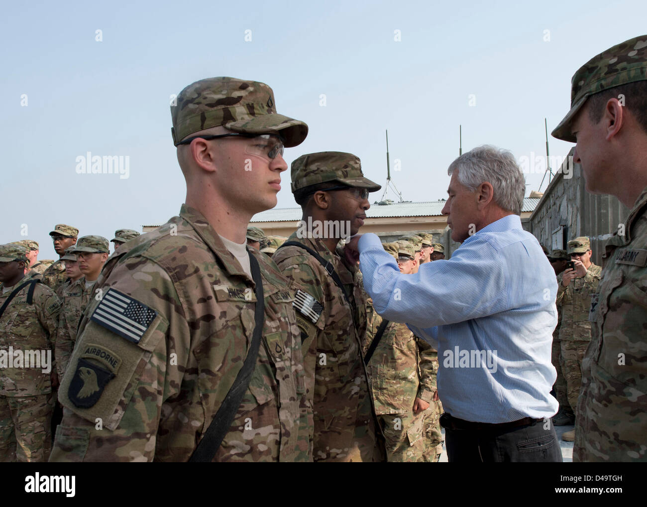 US Secretary of Defense Chuck Hagel awards a purple heart to a soldier March 9, 2013 in Jalalabad, Afghanistan. Hagel is in Afghanistan on his first trip as the Secretary of Defense and will meet with US troops, NATO and Afghan leaders. Stock Photo