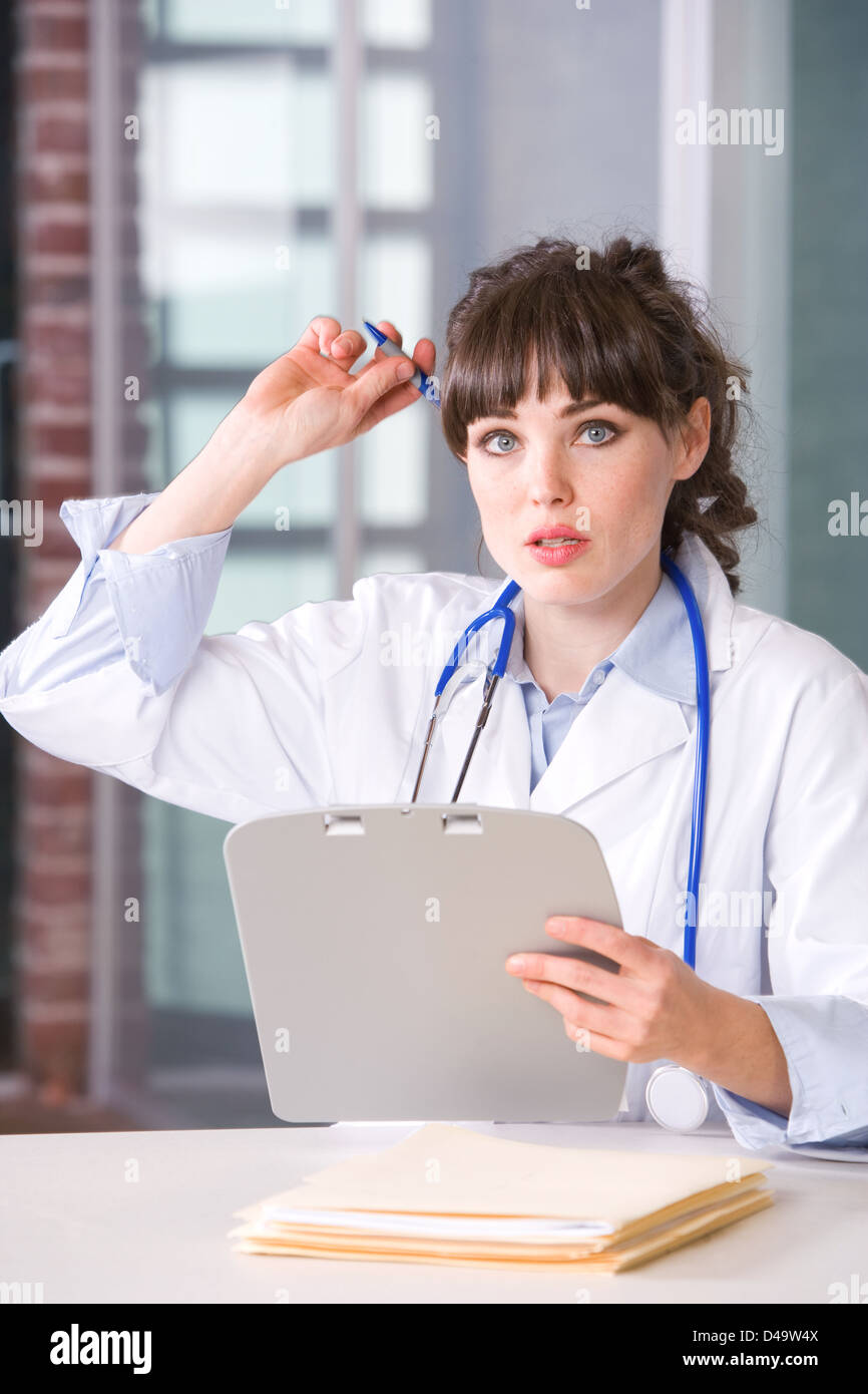 Female doctor in a modern office drinking coffee Stock Photo - Alamy