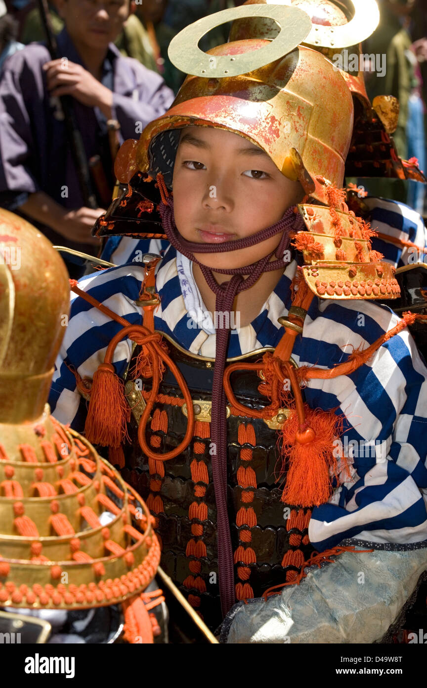 Young samurai warrior dressed in armor with helmet partakes in the annual spring Shunki Reitaisai Grand Festival parade in Nikko Stock Photo