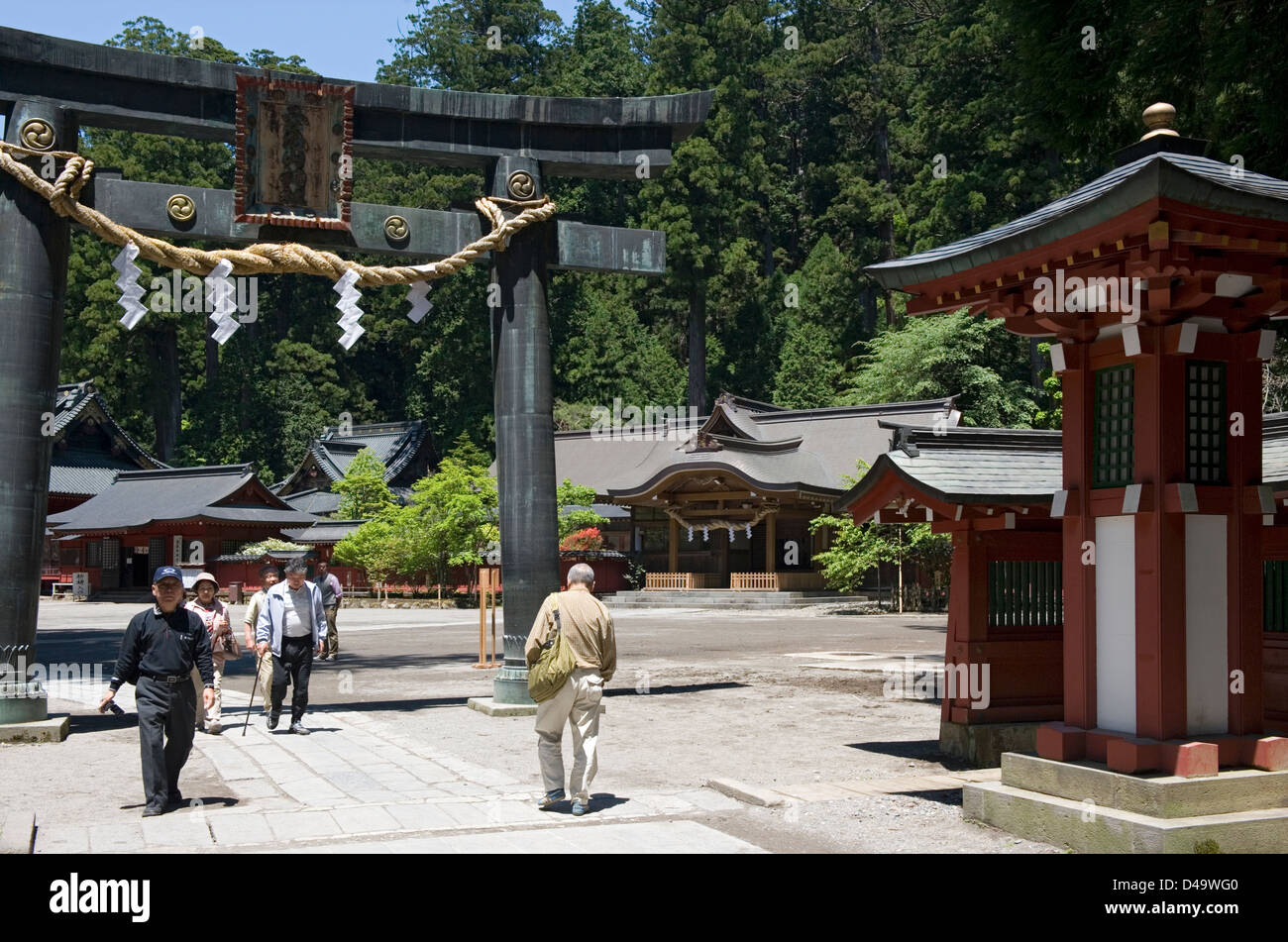 Visitors pass through a torii gate at Futarasan Shrine in Nikko, Tochigi, Japan. Stock Photo