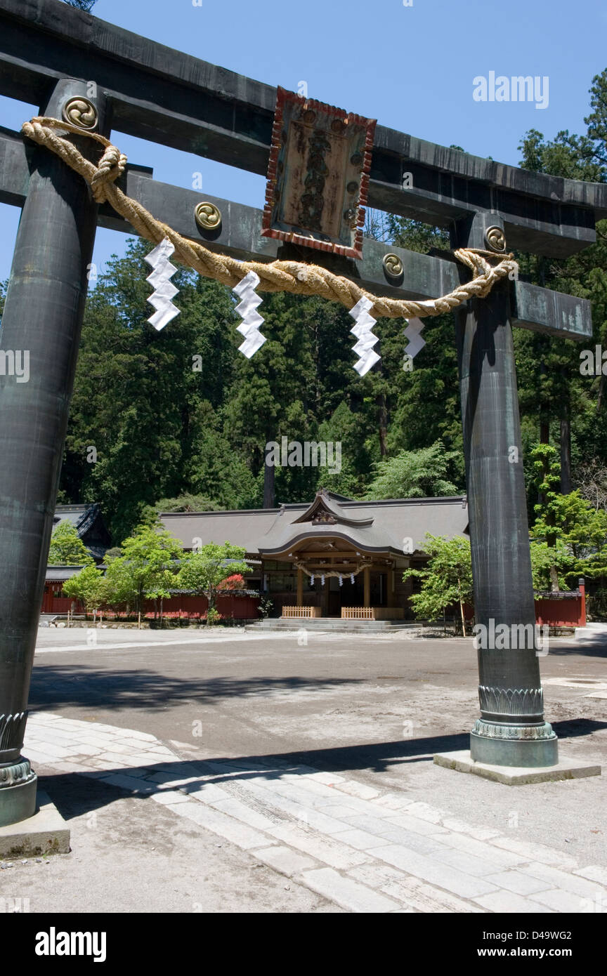 A sacred torii gate with twisted rope shimenawa at Futarasan Shrine in Nikko, Tochigi, Japan. Stock Photo