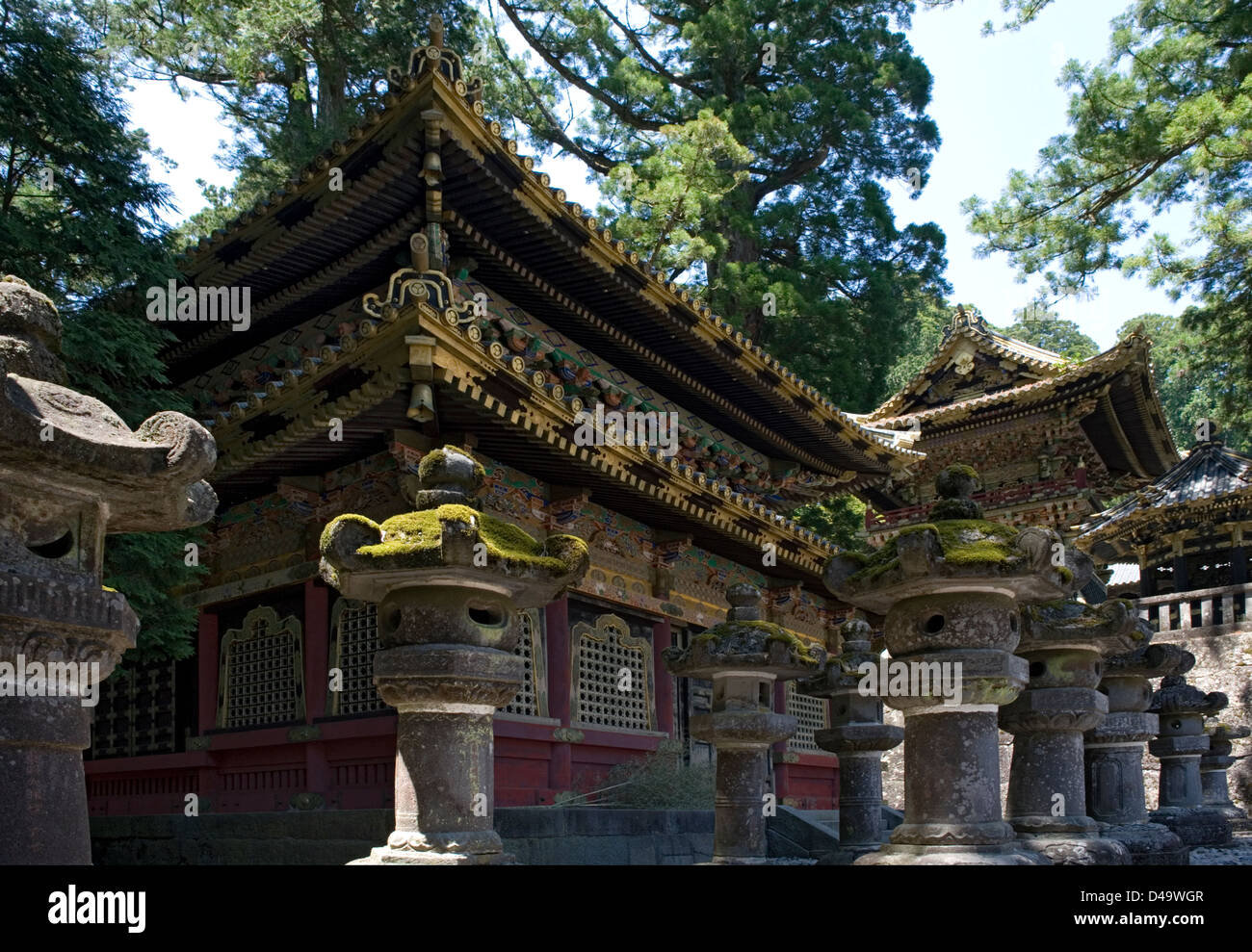 Ornate gold decorated sacred buildings surrounded by stone lanterns at Toshogu Jinja Shrine in Nikko, Tochigi, Japan. Stock Photo