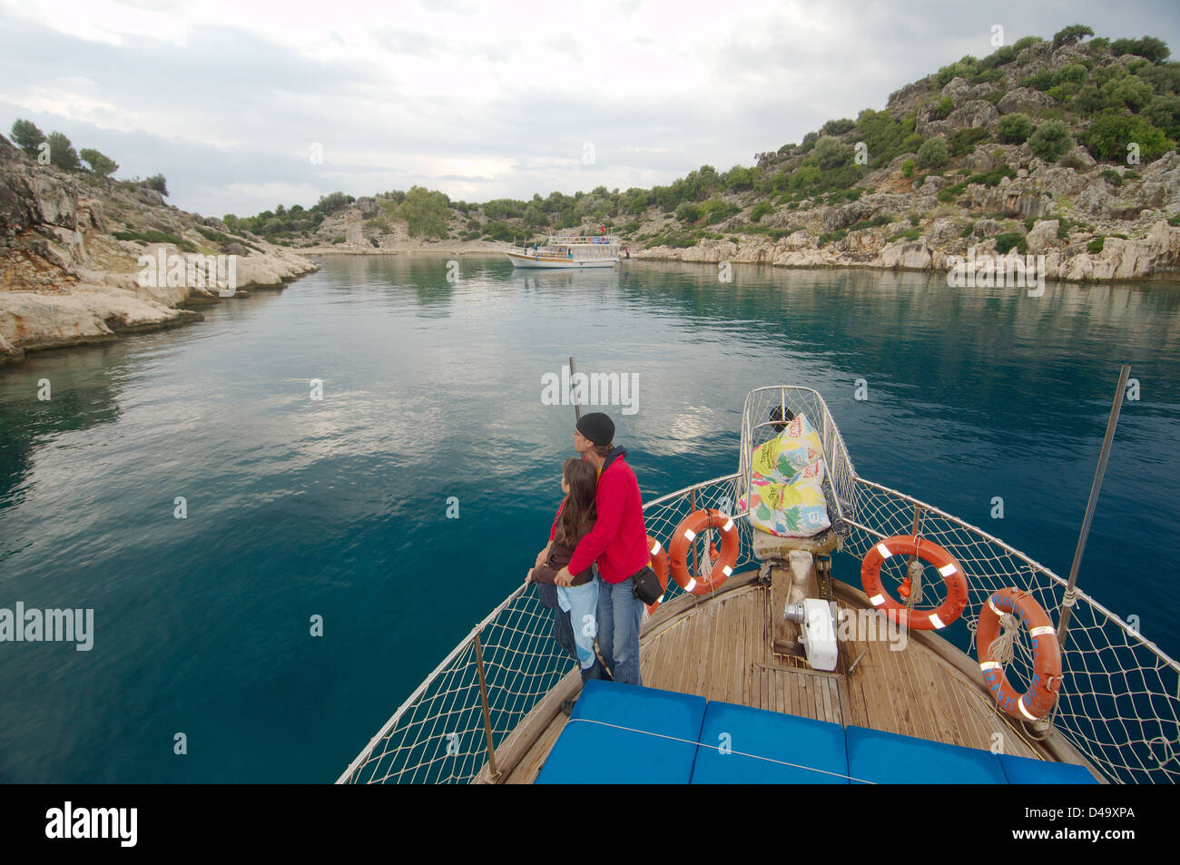 Tourists on the walking yacht look at ruins of the sunk city Kekova, Turkey Stock Photo