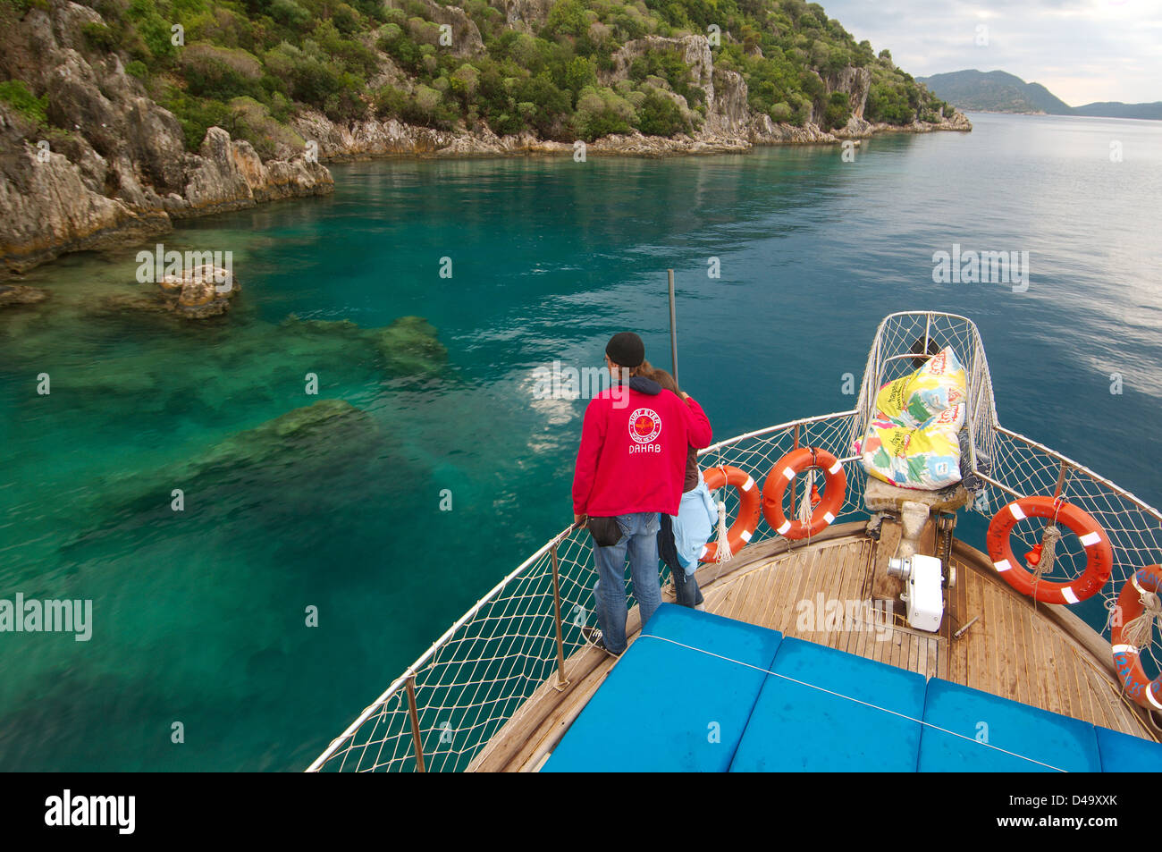 Tourists on the walking yacht look at ruins of the sunk city Kekova, Turkey Stock Photo