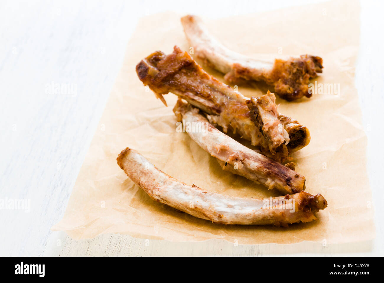 Rib bones picked clean of meat on parchment paper Stock Photo Alamy