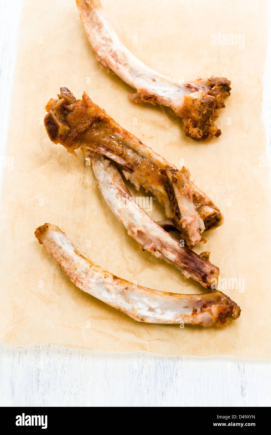 Rib bones picked clean of meat on parchment paper Stock Photo Alamy