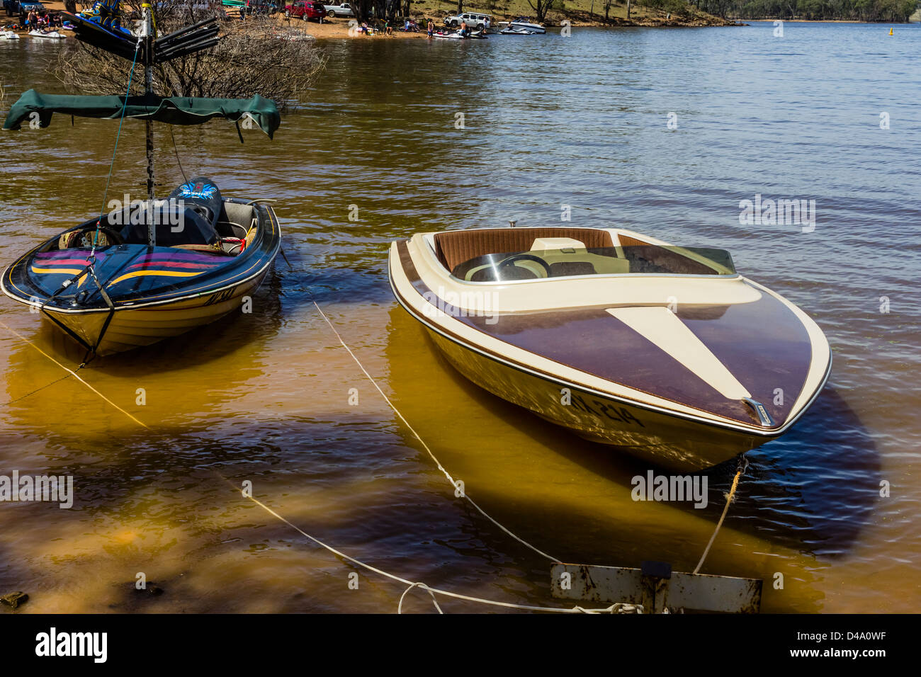 Waterski boats tied up on the shore of Lake Eppalock, Victoria Australia Stock Photo