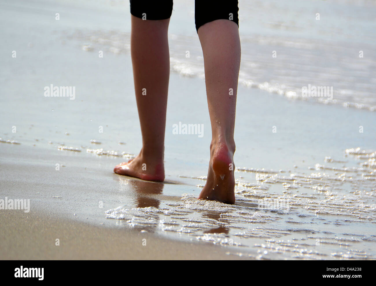 A walker on the beach of the Polish Baltic Sea in summer Stock Photo