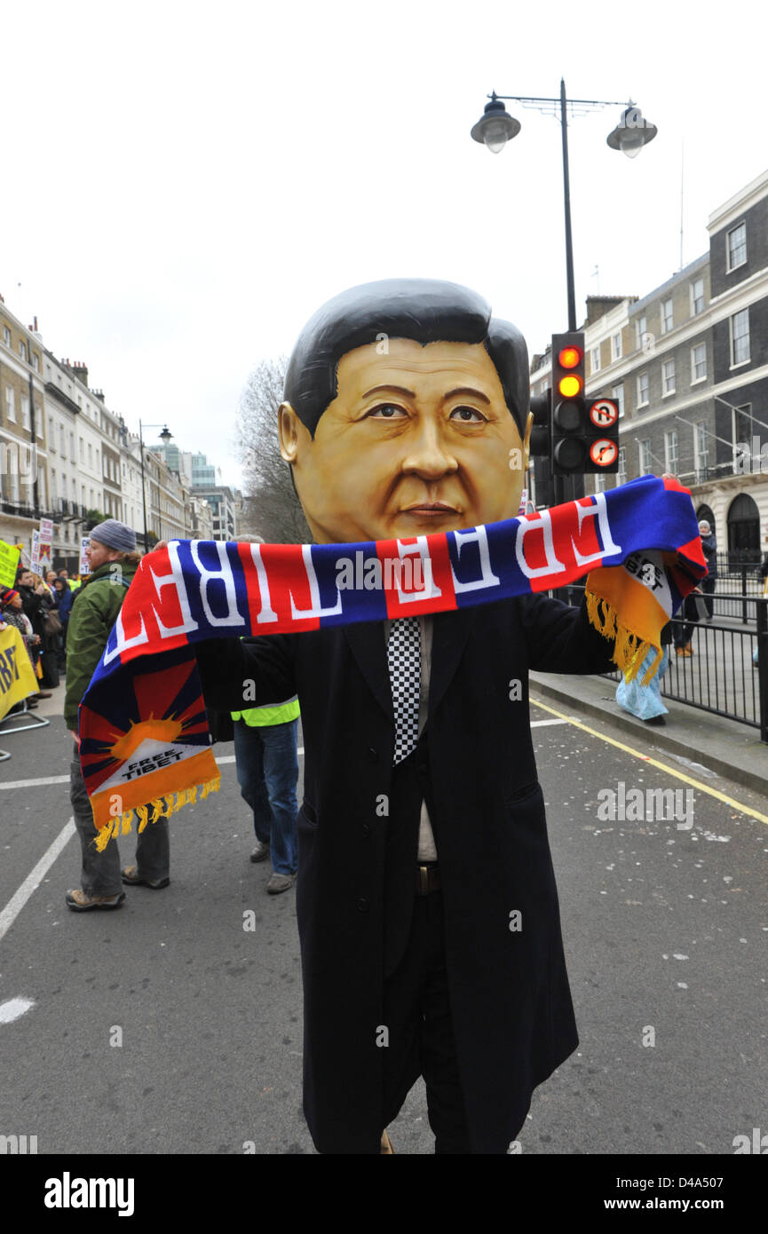 Portland Place, London, UK. 10th March 2013. A man wearing a mask of the new leader of the Chinese Communist party, Xi Jinping at the march to the Chinese Embassy. Tibetan people march through central London in protest against the Chinese involvement in Tibet, ending in a rally outside the Chinese Embassy on Portland Place, Stock Photo