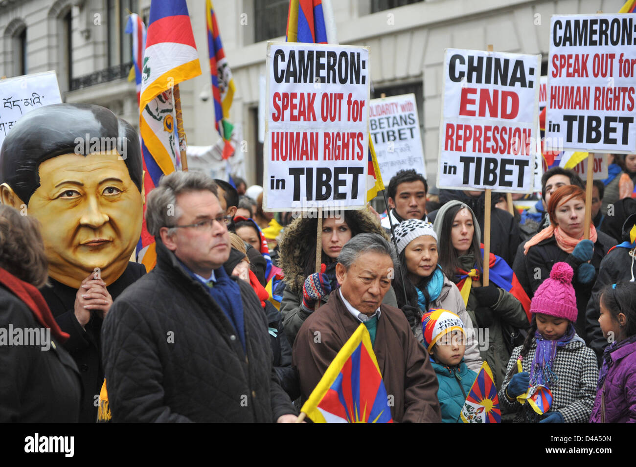 Portland Place, London, UK. 10th March 2013. A man wearing a mask of the new leader of the Chinese Communist party, Xi Jinping at the rally at the Chinese Embassy. Tibetan people march through central London in protest against the Chinese involvement in Tibet, ending in a rally outside the Chinese Embassy on Portland Place, Stock Photo
