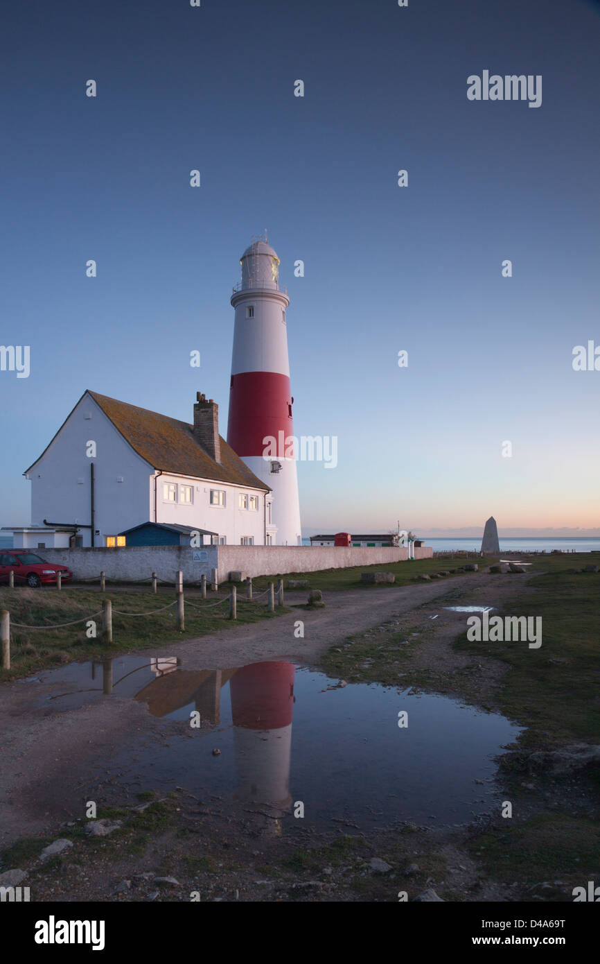 Portland Bill lighthouse, Dorset, England, reflected in puddle at twilight. Stock Photo