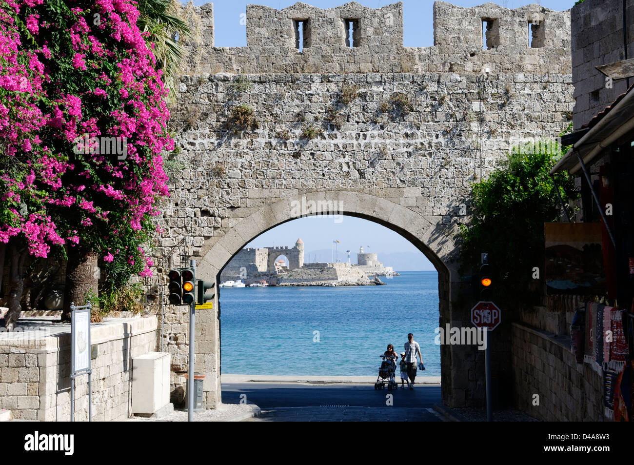 Rhodes. Greece. St Catherine’s Gate at the old town of Rhodes with ruins of St Paul’s gate and port of Rhodes in background Stock Photo