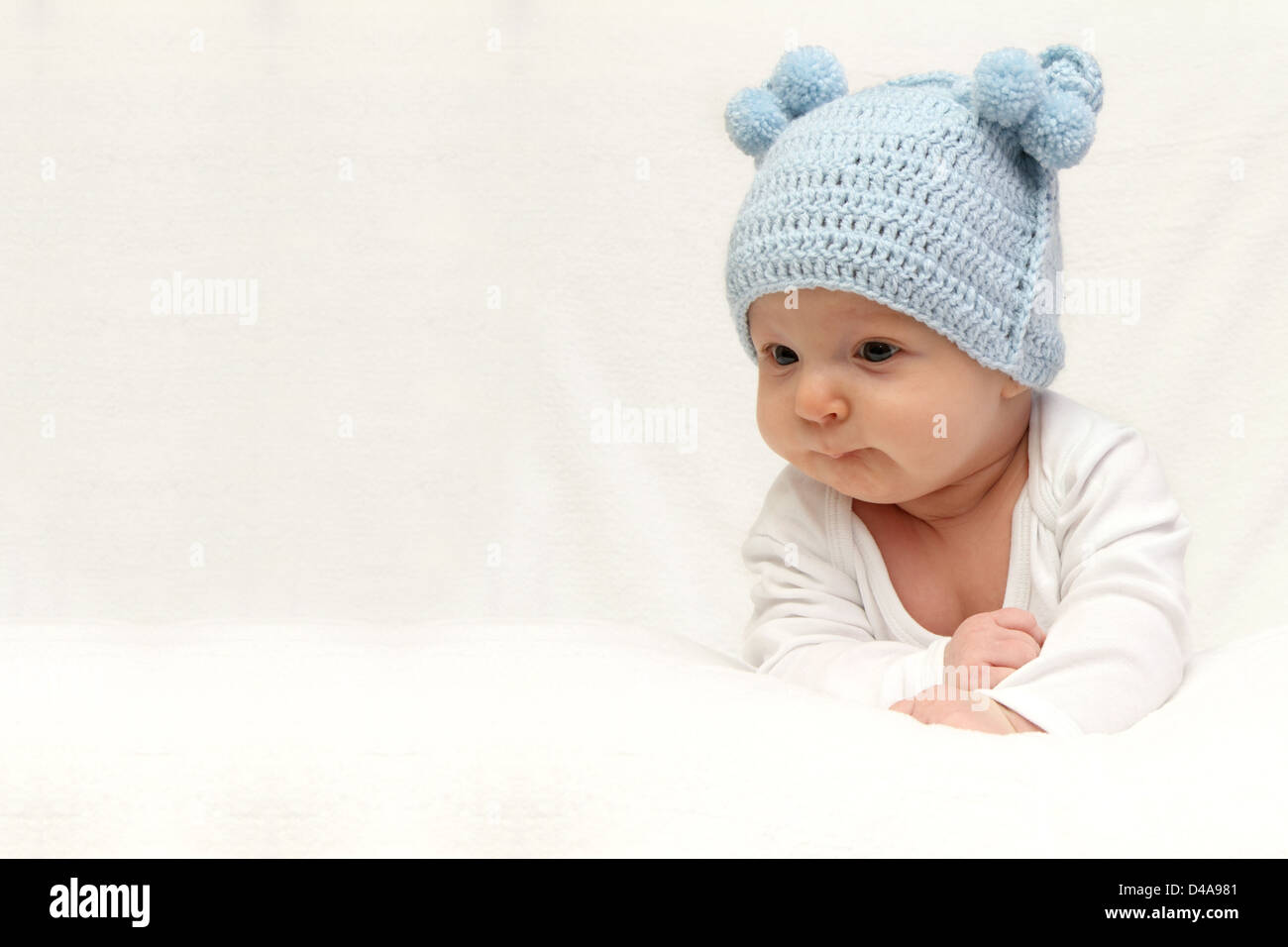 Beautiful baby in blue knitted hat Stock Photo