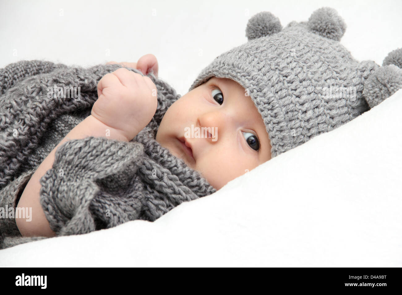 Beautiful baby in gray knitted hat Stock Photo