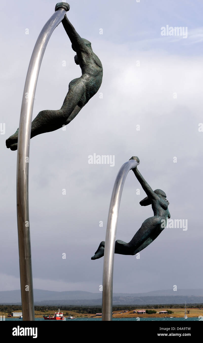 Statues of a man and a woman diving into Ultima Esperanza Sound. Puerto