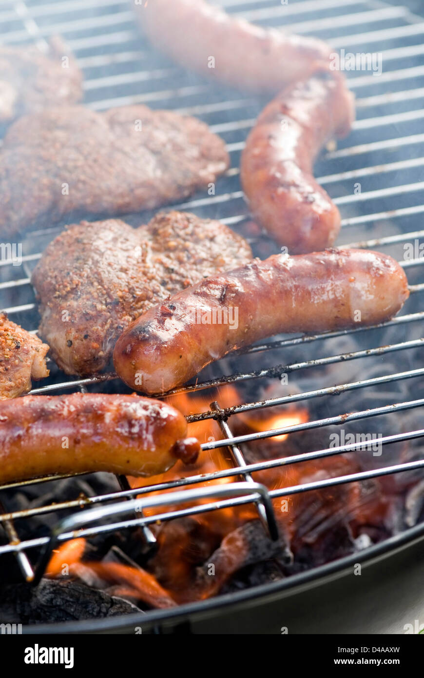 Sausages and hamburgers on barbecue Stock Photo