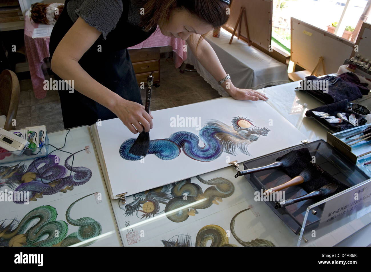 Woman artist making dragon art with a single brush stroke in her studio in Nikko, Japan. Stock Photo
