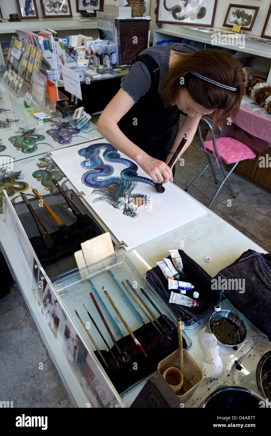 Woman artist making dragon art with a single brush stroke in her studio in Nikko, Japan Stock Photo