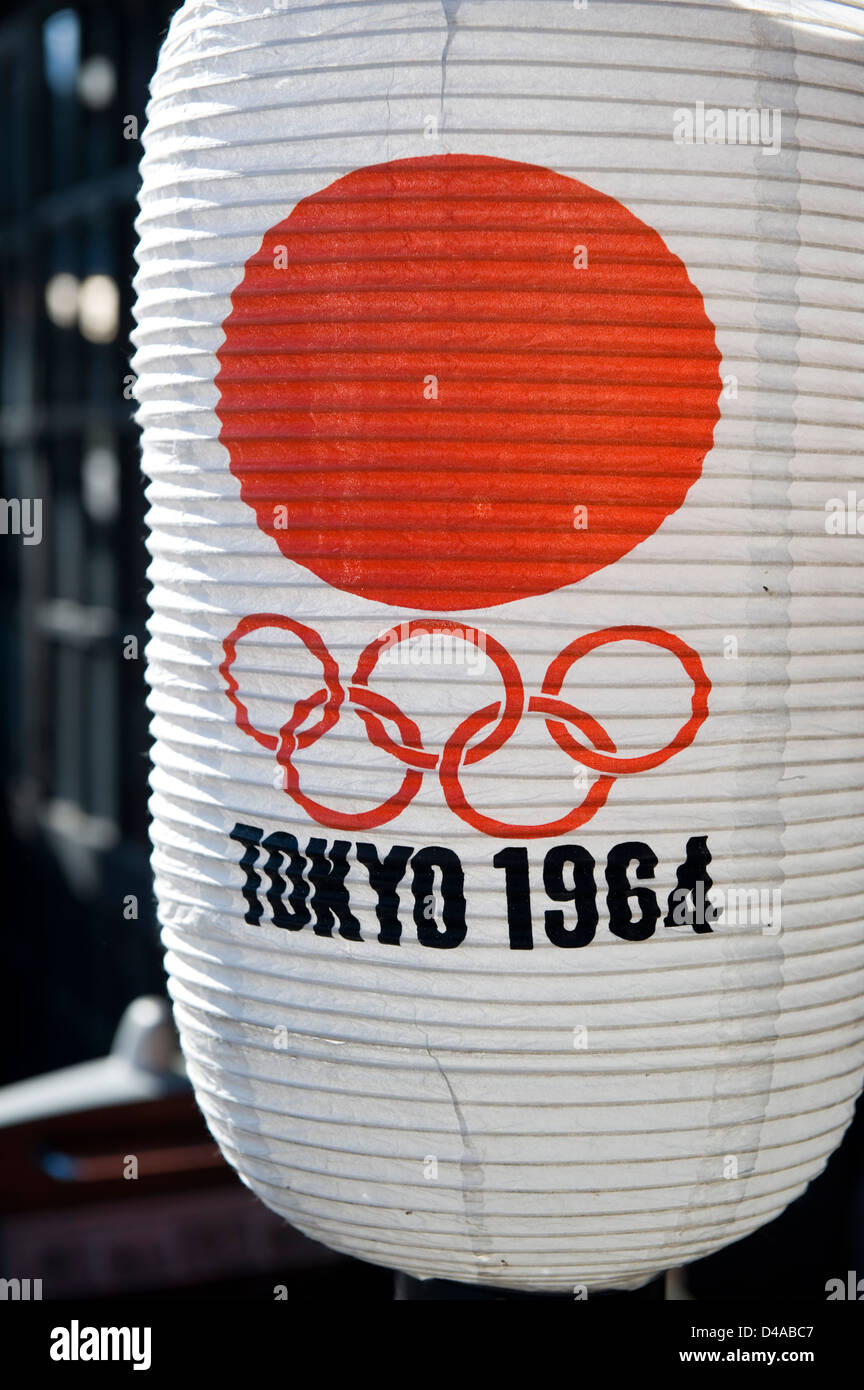 A paper chochin lantern from the 1964 Tokyo Olympic Games with a red rising sun against a white background. Stock Photo