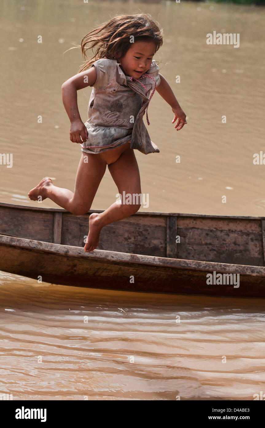 Lanten girl jumping out of her dugout canoe on the Nam Ha 