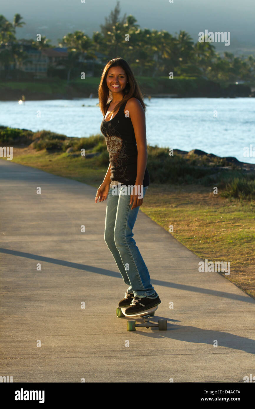 Beautiful, healthy young woman in Kihei, Maui, Hawaii rides a skateboard  Stock Photo - Alamy