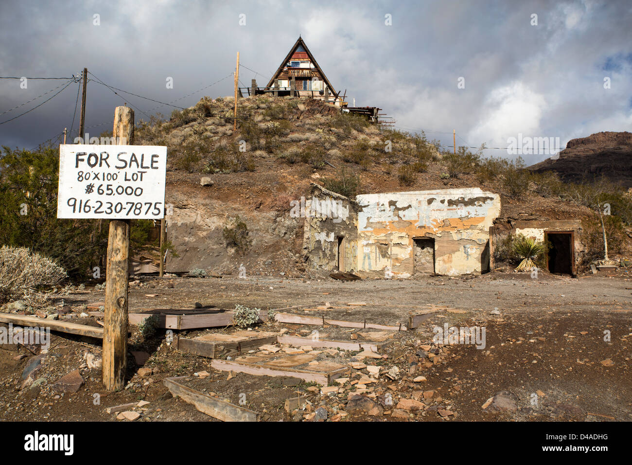 A house on the top of a hill with a lot for sale in the