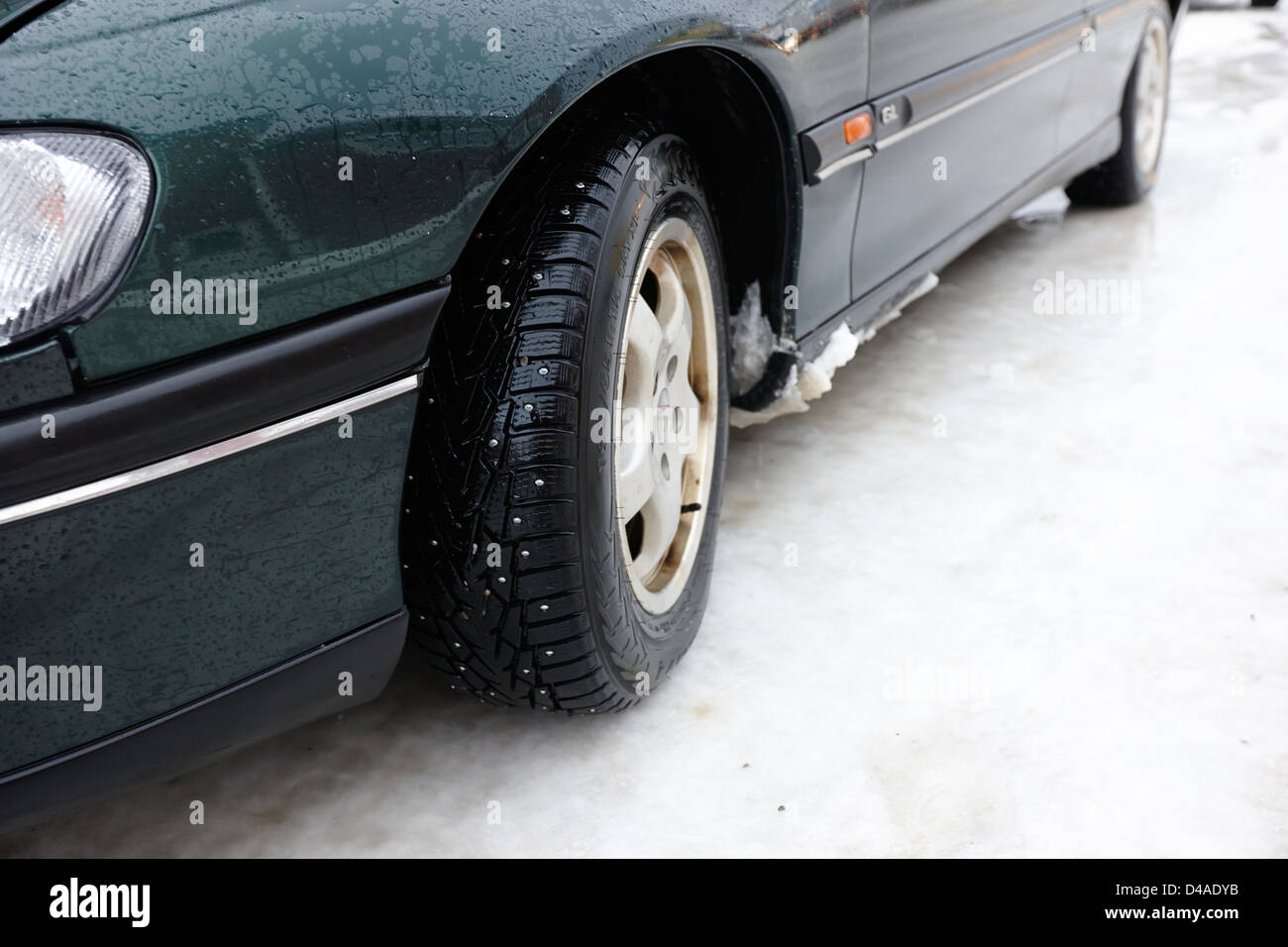 car with studded winter tyres on ice norway europe Stock Photo