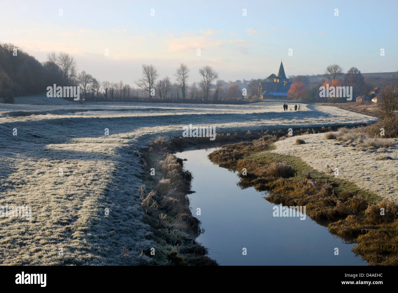 Alfriston village seen from the banks of the Cuckmere River on a frosty morning, with Alfriston church in the distance. Stock Photo