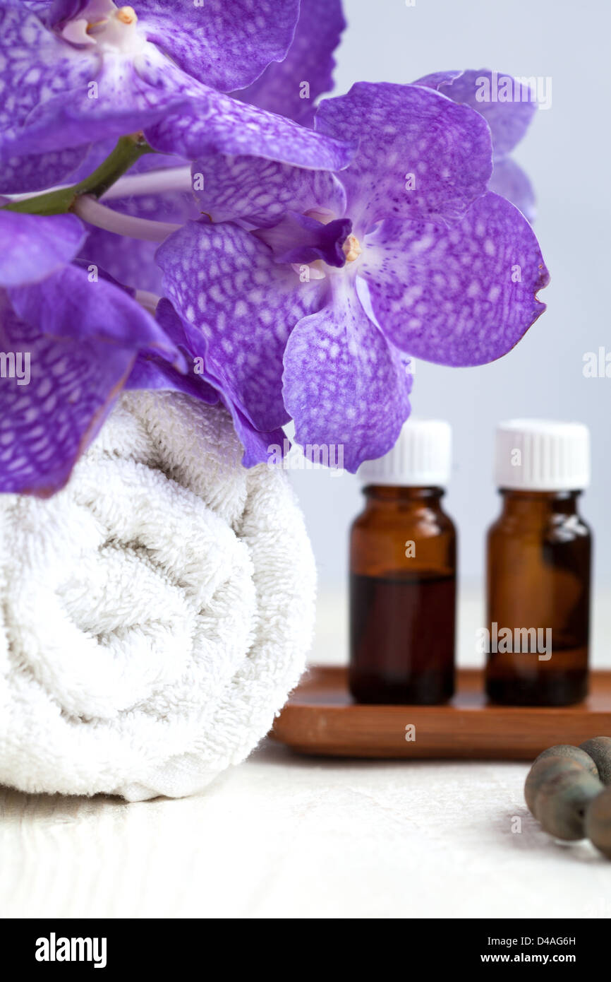 Spa still life with blue orchid flower, towel and aromatic oils, Focus