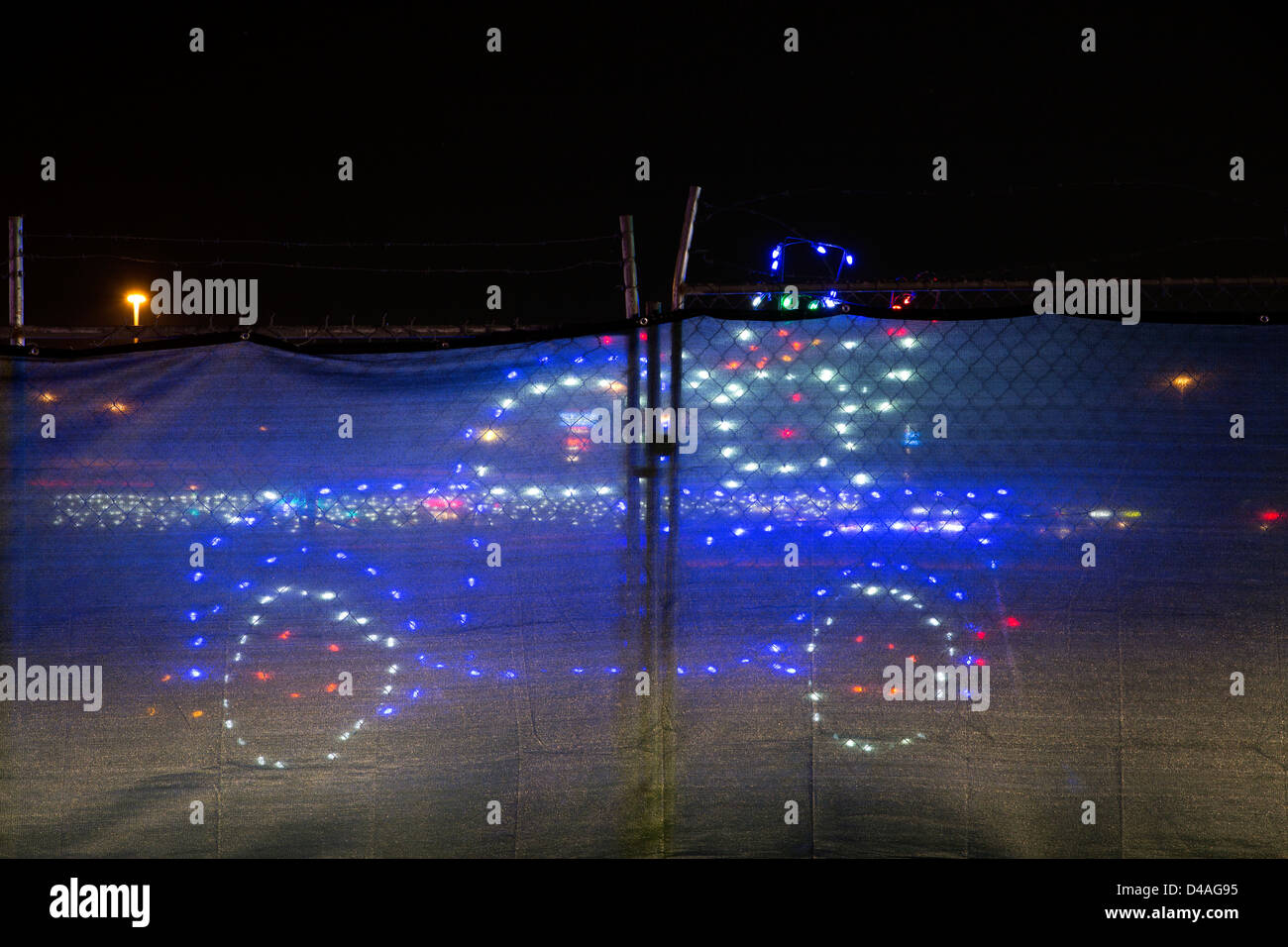 A blue car behind a fence , Christmas decoration at Arizona Celebration of Lights show. Stock Photo