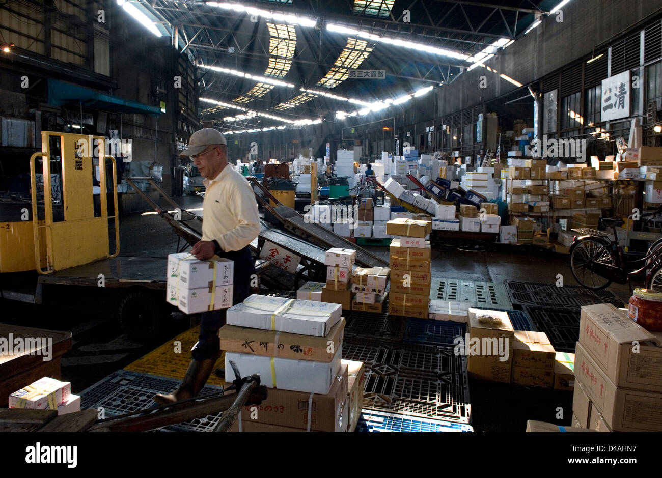 Sunlight filters in through skylights in the distribution and packaging section of Tsukiji Wholesale Fish Market in Tokyo. Stock Photo