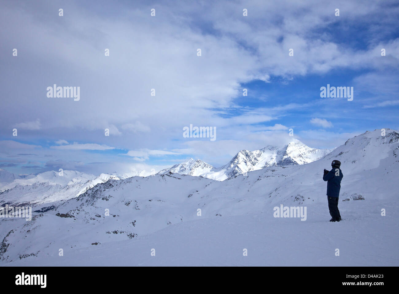 Skier viewing Mont Blanc Massif, from La Combe red piste, Glacier de la Chiaupe, La Plagne, French Alps, Savoie, France, Europe Stock Photo